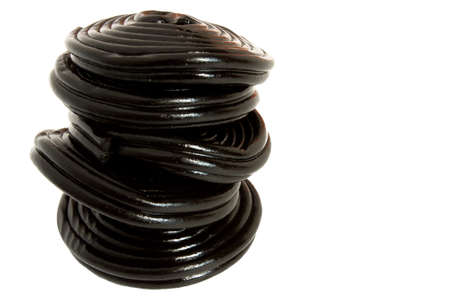 Halloween treats - Liquorice black gummy candies - macro, isolated on white background.の写真素材
