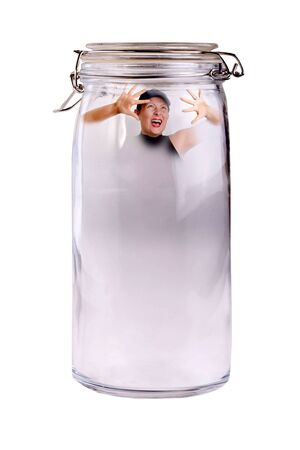 Conceptual - Woman screaming trapped in a jar. Concepts: fear, isolation.の写真素材