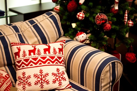 Sofa decorated for Christmas with red and white pillow.の写真素材