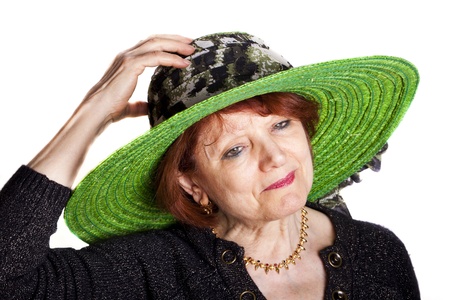 Elegant senior woman wearing a green hat.の写真素材