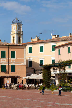 Porto Azzurro, Elba Island, Italy, October 30, 2011 - Central square (Piazza Matteotti), full of people enjoying the beautiful sunny day.のeditorial素材