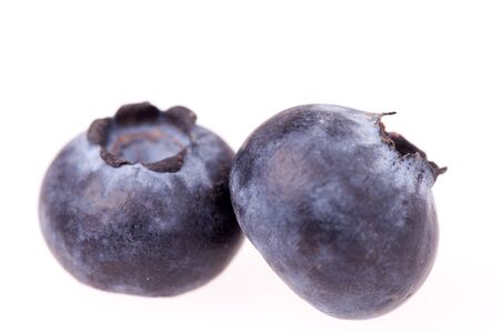 Extreme closeup of blueberries isolated on white background の写真素材