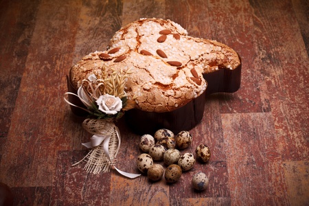 Traditional Italian desserts for Easter - Easter dove and quail eggs, on wood table.の写真素材