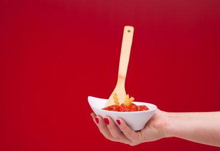 Italian Cuisine - Bowl with ragù holded in hand の写真素材