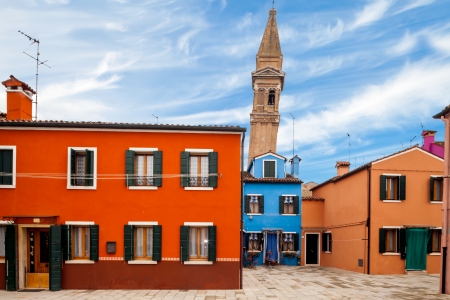 Leaning tower and colorful buildings in Burano, Italy.の写真素材