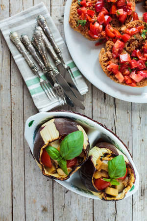 Overhead shot of table with stuffed baked eggplants and bruschetta.の写真素材