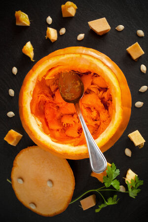 Overhead shot of pumpkin during the operation of carving.の写真素材