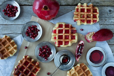 Crisp golden fresh baked waffle topped with pomegranate sorbet, overhead shot.の写真素材