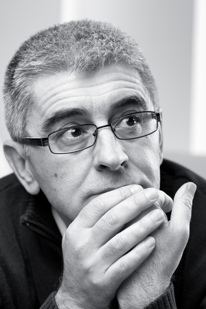 Portrait of thoughtful man looking away, black and white photo.の写真素材