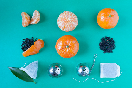 Deconstructed tangerines tea. Composition with tangerines, dry tangerines tea, tea bags and tea strainer.の写真素材