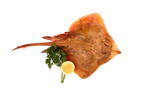 Fresh ray fish isolated on white background, with lemon and parsley.の写真素材