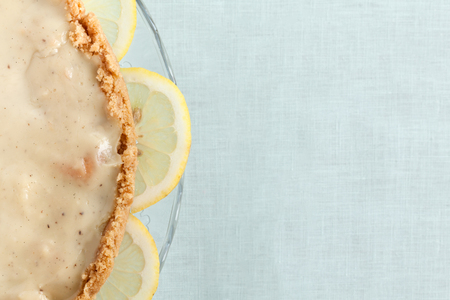 Half tart with custard cream and lemons, overhead shot.の写真素材