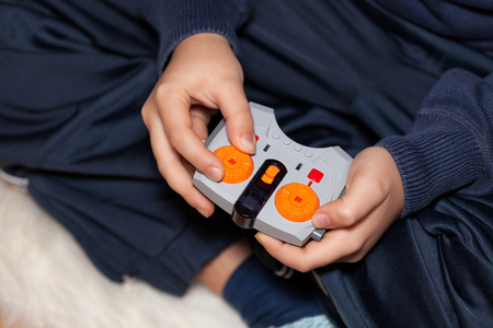 Closeup of boy hands holding a toy remote control.