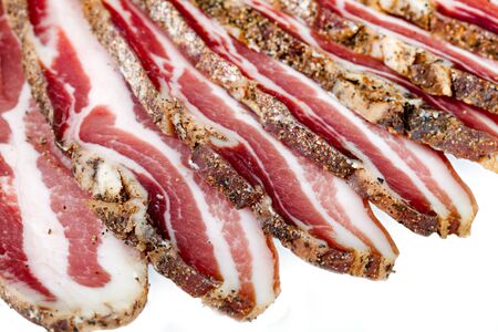 Smoked bacon slices over white background.の写真素材