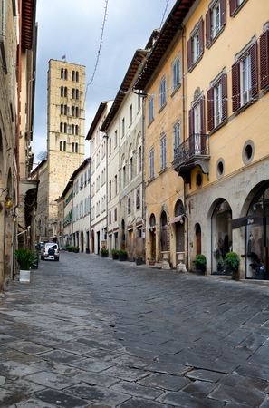 AREZZO, ITALY - JANUARY 9, 2016:  Corso Italia and, in the background, the XIV century bell tower of Santa Maria della Pieve church with its sturdy appearance with five rows of mullioned windows.のeditorial素材