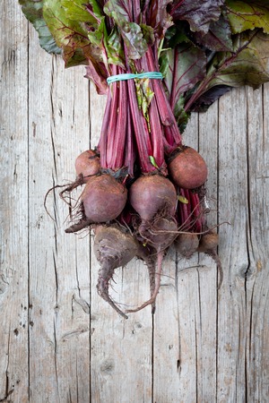 Fresh red turnips, just picked from the market, photographed on wood background.