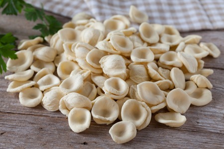 Fresh orecchiette, traditional italian pasta, photographed on wood background.の写真素材