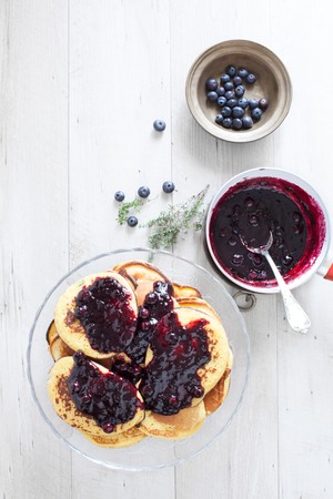 Breakfast table with blueberry cakes garnished with blueberries jam.の写真素材