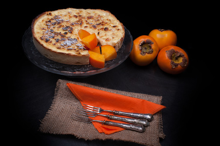 Fresh baked persimmon cake made with persimmon jam, almonds, custard and ricotta cheese.の写真素材