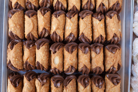Top view of tray with chocolate cannoli, typical Sicilian sweets.の写真素材