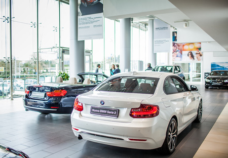 ROME, ITALY - MARCH 10, 2014: Agents selling BMW cars inside car dealer showroom. The BMW Group recorded increasing of sales in Italy.のeditorial素材