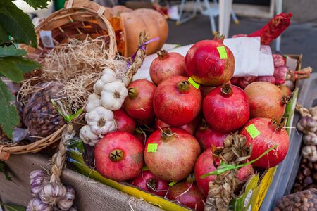 Autumn fruits and vegetables on sale in market stall.の写真素材