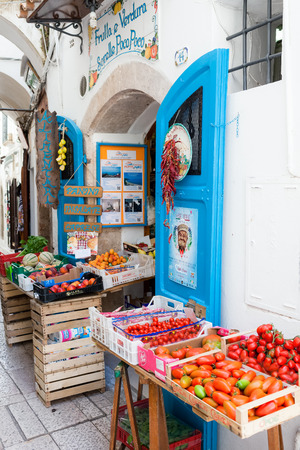 SPERLONGA, LAZIO, ITALY - MAY 30, 2016: Frutta E Verdura Sorelle Poco Poco, old typical fruits and vegetables shop in the old historical part of the village selling fresh mediterranean products.のeditorial素材