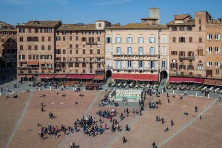 SIENA, TUSCANY, ITALY - MARCH 14, 2014: Piazza del Campo full of tourists, view from Mangia Tower. Piazza del Campo is the principal public space of the historic center of Siena.のeditorial素材