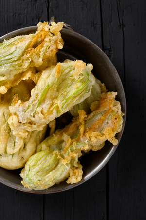 Plate with fried zucchini flowers, typical plate of the Italian cuisine. Top view shot.の写真素材