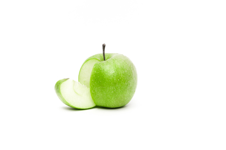 Gorgeous ripe fresh apple with a sliced piece falling from itの写真素材