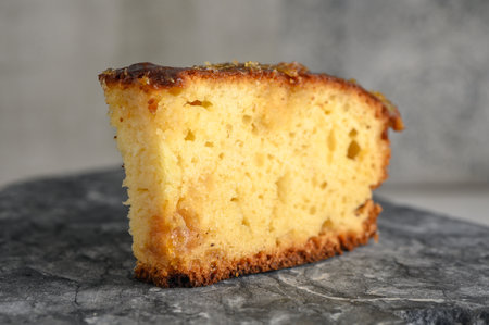 piece of pie with orange jam on a stone kitchen surfaceの写真素材