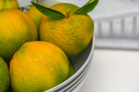delicious fresh green-orange tangerines in a light plate 3の写真素材
