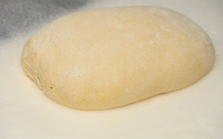 dough for homemade bread lies on the kitchen table before going into the oven 1の写真素材
