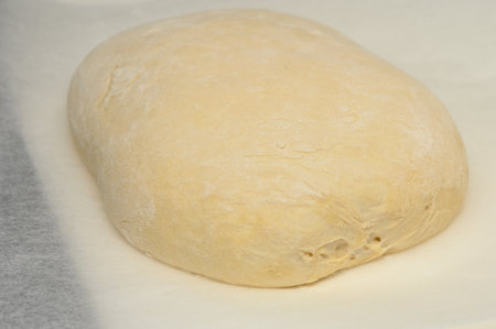 dough for homemade bread lies on the kitchen table before going into the oven 14の写真素材