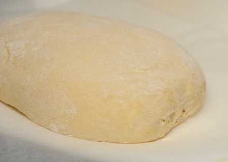 dough for homemade bread lies on the kitchen table before going into the oven 4の写真素材