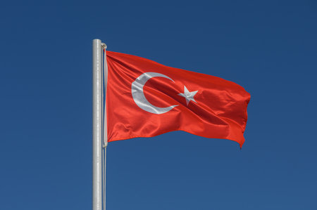 Turkey flag against blue skyの写真素材