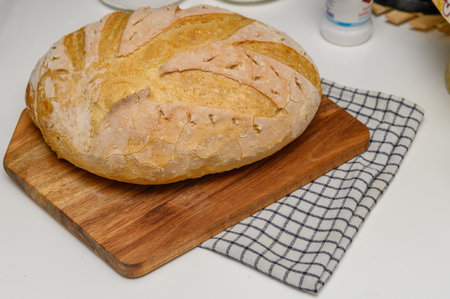freshly baked homemade bread on the kitchen table on a light background 7の写真素材