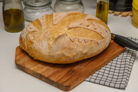 freshly baked homemade bread on the kitchen table on a light background 1の写真素材