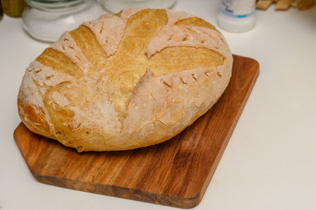 freshly baked homemade bread on the kitchen table on a light background 8の写真素材