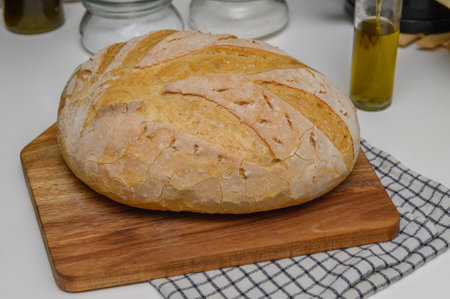 freshly baked homemade bread on the kitchen table on a light background 6の写真素材