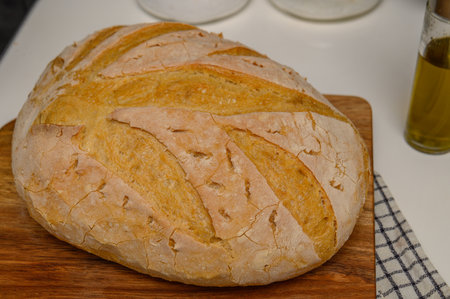 freshly baked homemade bread on the kitchen table on a light background 5の写真素材