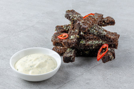 fried slices of black bread on a stone background studio food photo