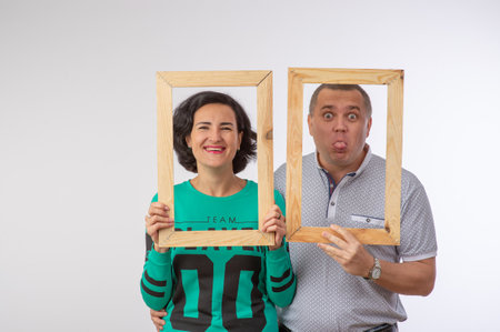 studio portrait of husband and wife in photo frame happy familyの写真素材