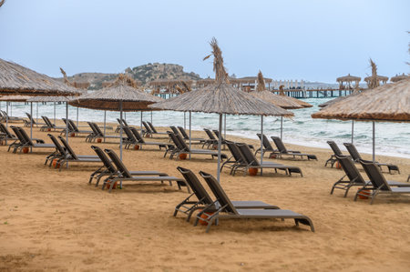 Mediterranean beach with sun loungers and sun umbrellasの写真素材