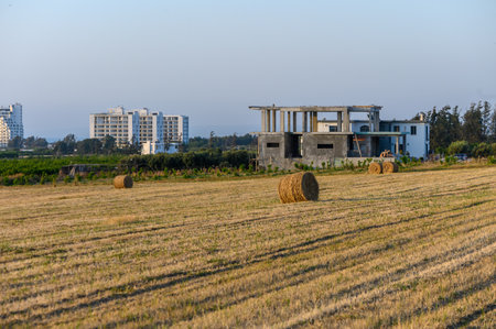Straw bales on farmland with blue cloudy sky
