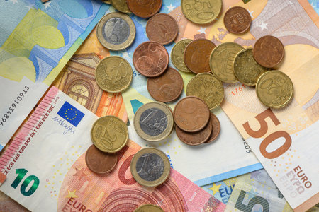 A combination of different Euro banknotes and Euro coins as a closeup 1