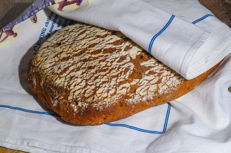 homemade rye bread in a towel on the table