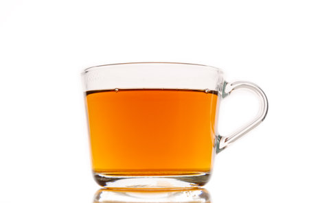 Glass cup of hot aromatic tea on white backgroundの写真素材