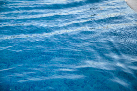 A blue pool shines on a summer dayの写真素材