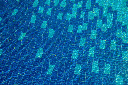 Beautiful sun reflections of water in the pool. Summer. Blue water. Background. Rest in the pool. Pure water. Waves. Blue background.の写真素材